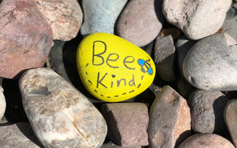 Pebble with the words 'Bee kind' painted onto it