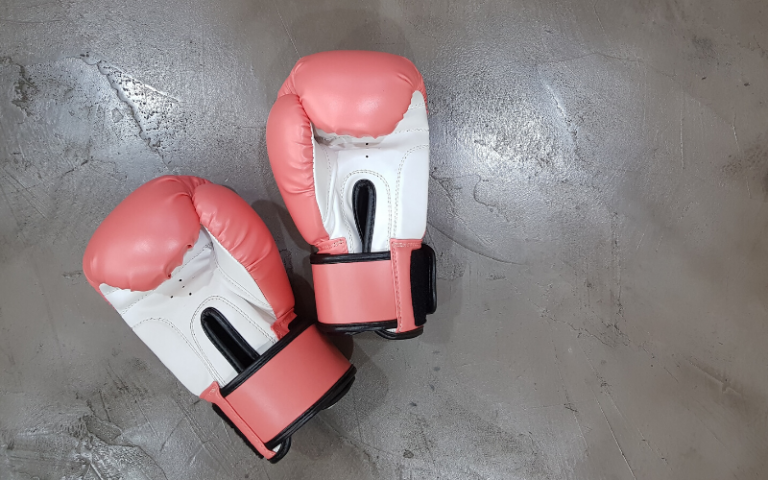 Pink boxing gloves on floor