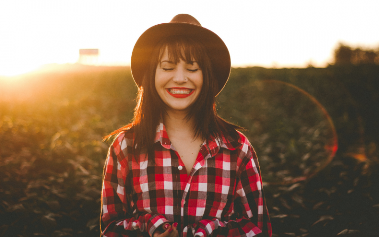 Woman in a hat smiling in the sunshine