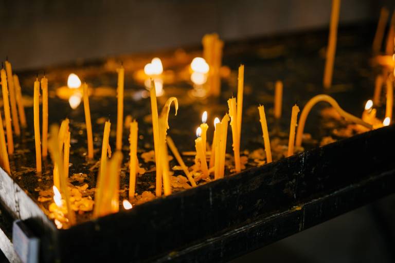 Lit candles being used in religious observance