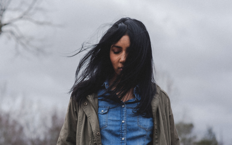 Girl with sad expression in denim shirt