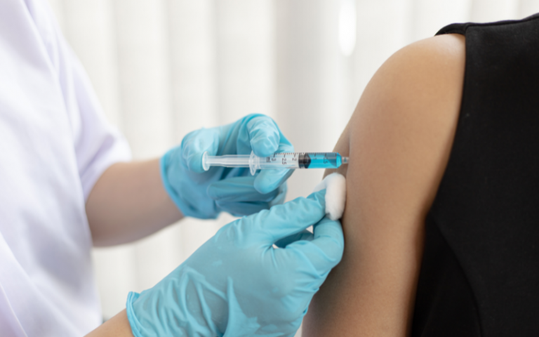 A person getting a vaccination in their arm