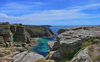 seaside landscape with cliffs and blue sea in Cornwall in the UK