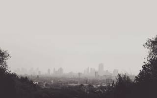 black and white misty photo of the london skyline