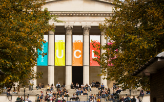 UCL Portico with trees and 'UCL' flags