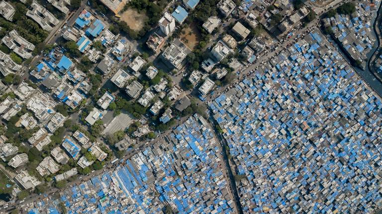 Overhead image of a slum next to spacious housing.