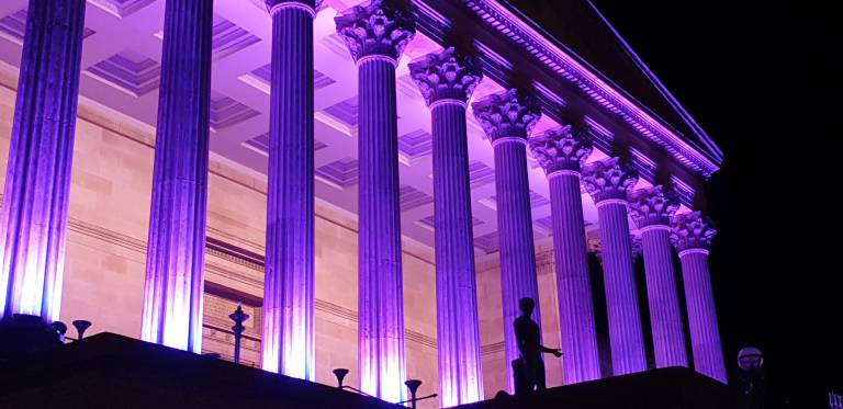Portico building lit up purple to celebrate international day of persons with disabilities