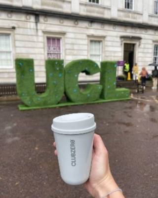 Image of Club Zero cup in front of large green UCL letters