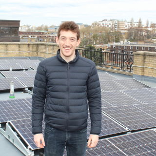 Arran from the Clean Energy Projects Society in front of solar panels