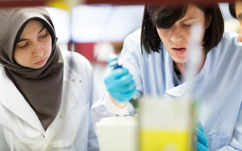 Two women in a lab doing an experiment