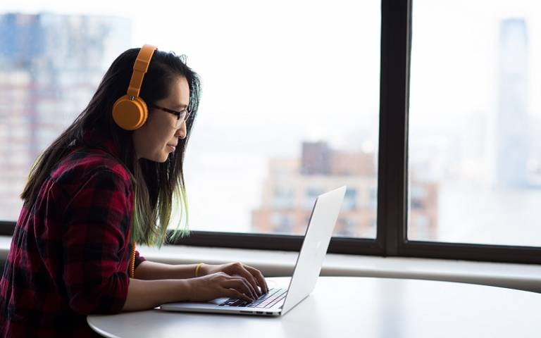 Student with headphones at laptop. Image by Christina-Wocintechchat / Unsplash