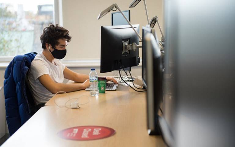 Student wearing mask working at a PC
