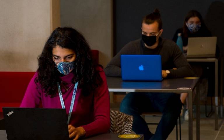 Students wearing masks with laptops 