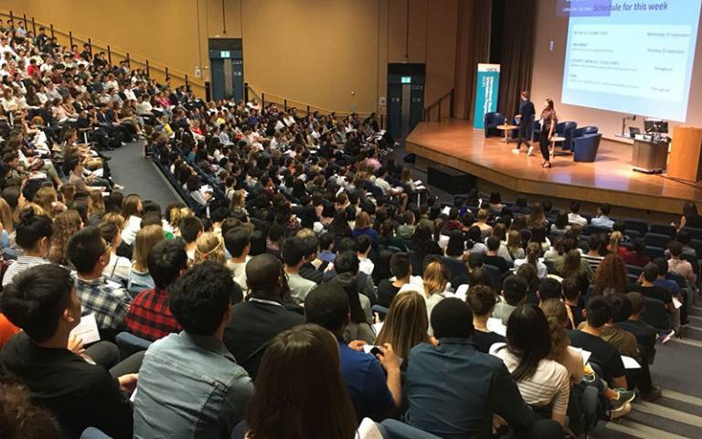 students in a large lecture hall listening to a presentation at the start of term at UCL