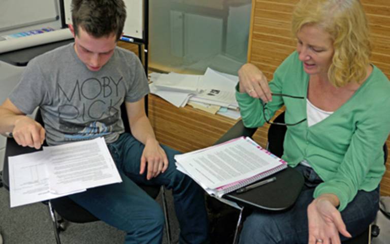 A student discusses work with their tutor at UCL
