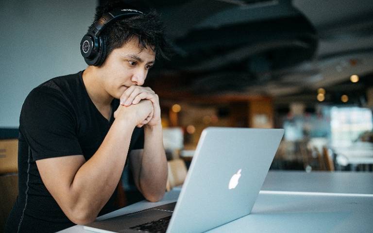 Man on a laptop with headphones on. Wes Hicks / Unsplash.com