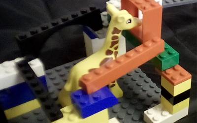 a lego giraffe with walls built around it