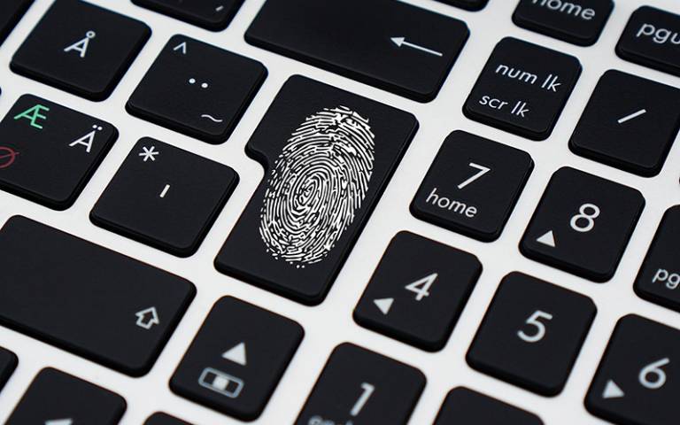 Stock image of a fingerprint on a keyboard