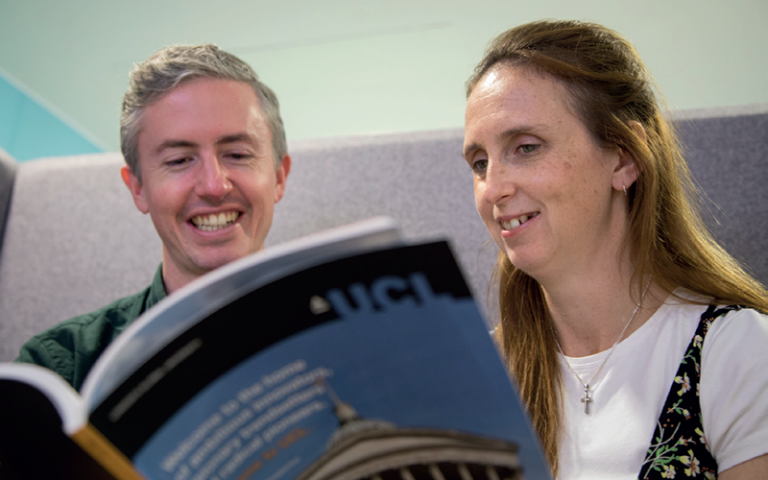 Image of two staff members reading the Career Framework booklet