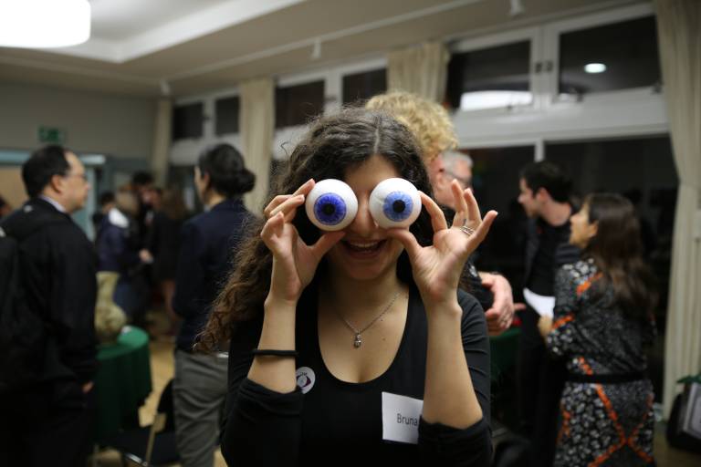 Female festival participant holds fake eyeballs