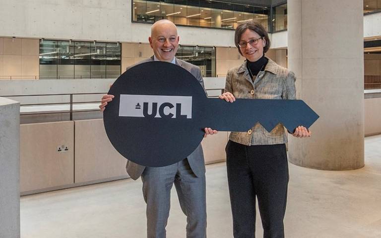 Kevin Kilcoyne, Project Director, Mace Construction Group hands a giant black key with a large UCL logo on it to Prof Paola Lettieri FREng, Pro-Provost, UCL East campus