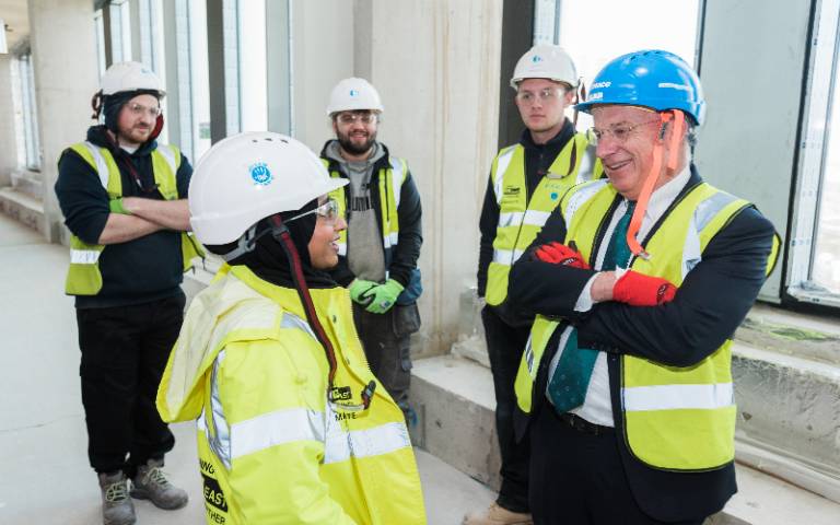 MACE construction apprentice Rayhana Rahman chats to UCL Provost Dr Michael Spence as other apprentices listen