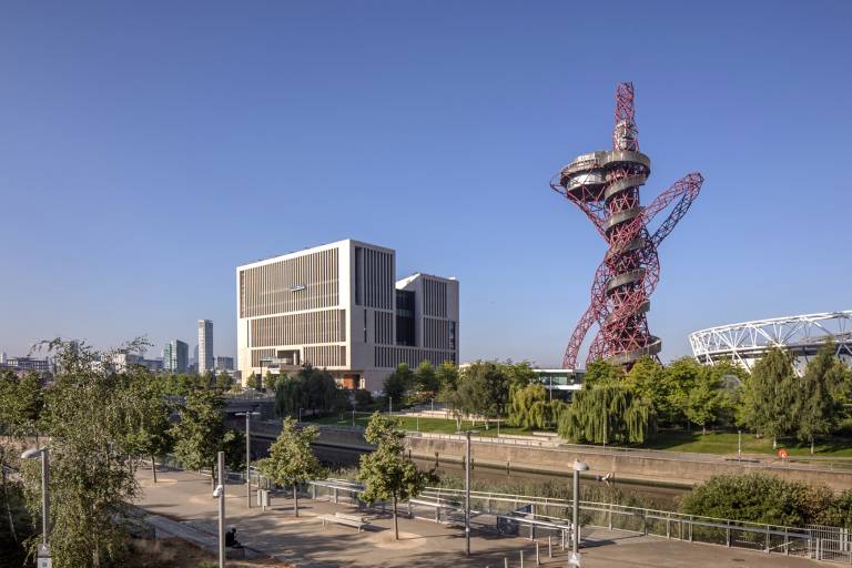 UCL's new Marshgate building next to the ArcelorMittal Orbit sculpture and river on Queen Elizabeth Olympic Park