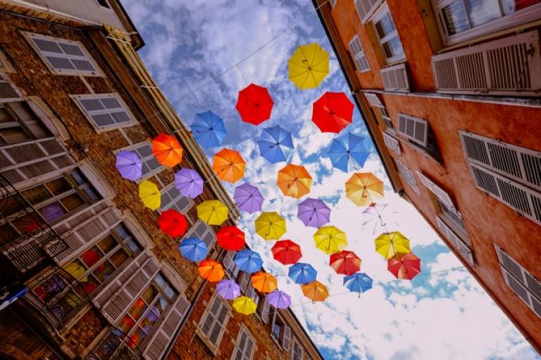 Photo of colourful umbrellas suspended in the middle of a street