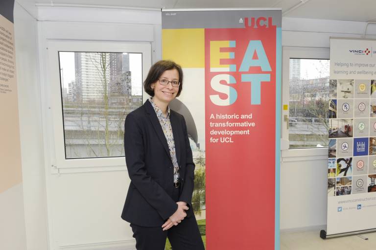 Photo of Paola Lettieri in front of a UCL East pull up banner