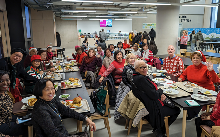 members of the local community sitting in the marshgate refectory for a festive dinner