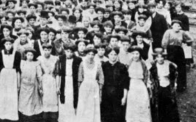 Archive black and white photograph of women standing in a crowd.