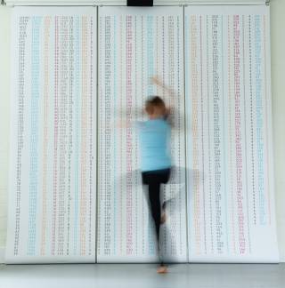 moving dancer in front of patterned wall
