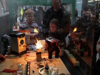 children looking at burning podium during open day experiment