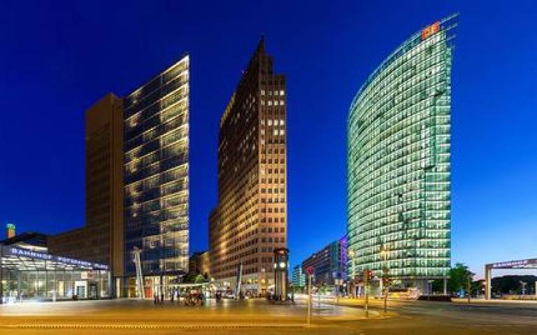Skyscapers at Potsdamer Platz, Berlin at the end of the blue hour. Buildings and their architects from left to right: Atrium-Tower (Renzo Piano), Kollhoff-Tower (Hans Kollhoff), BahnTower (Helmut Jahn). Credit: Ansgar Koreng on Wikimedia Commons