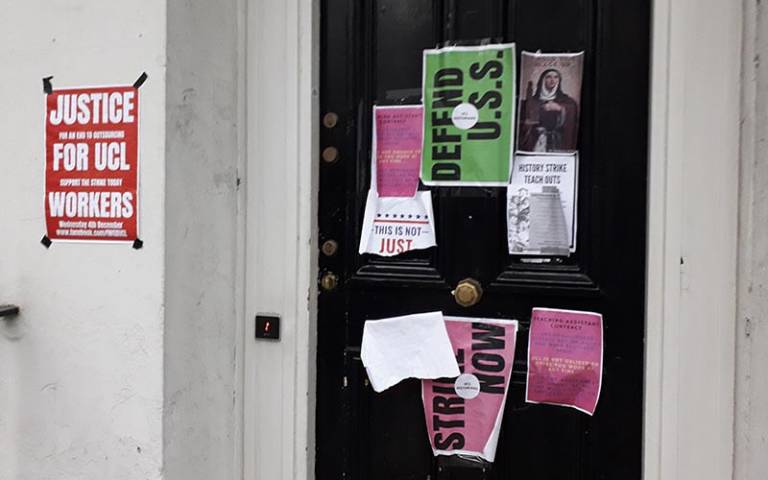 Door covered in posters promoting strikes at UCL