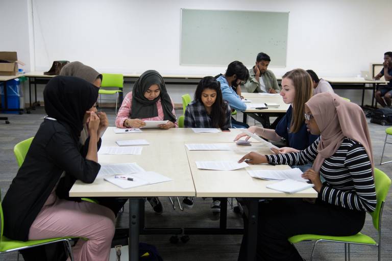 masterclass participants sat at a table in a modern ucl classroom