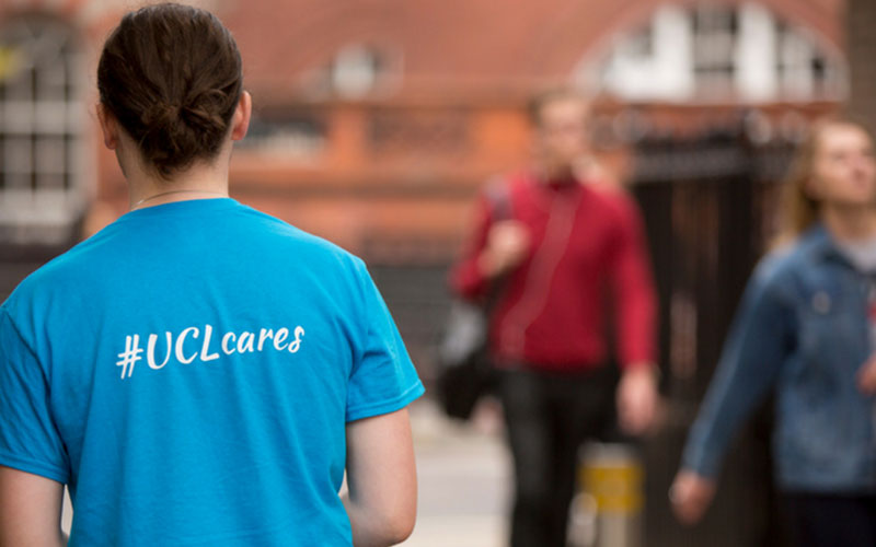 A UCL helper wearing a UCL Cares T-shirt
